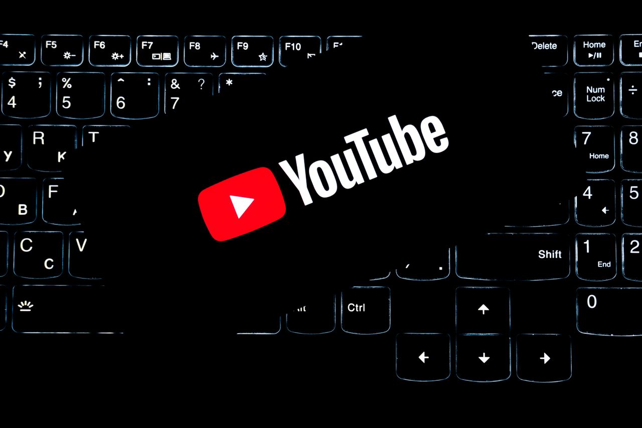 services-03 YouTube logo displayed on a backlit keyboard, representing digital media and online content creation.